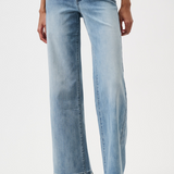 Light blue jeans worn by a person on a white background