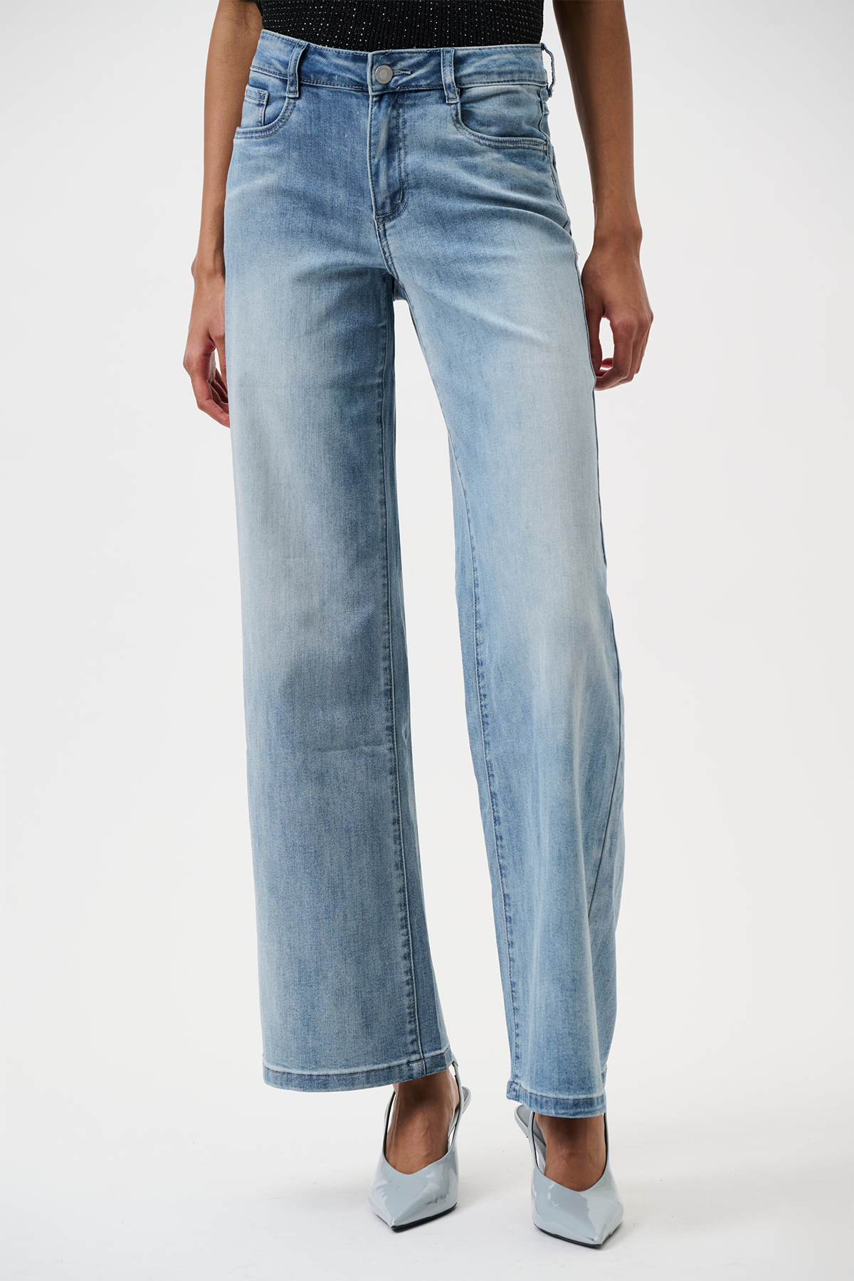 Light blue jeans worn by a person on a white background