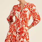 Woman wearing a red and white patterned dress on a beige background