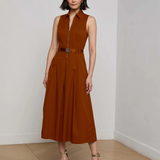 Model wearing a burnt orange midi dress with a white background. 