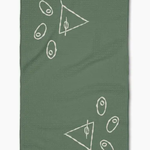 A sage green waffle-weave kitchen towel featuring white minimalist line-art drawings of martini glasses with olives, shown flat against a white background.