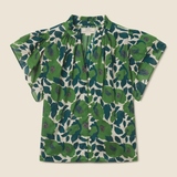 green floral blouse on tan background 