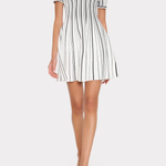Woman wearing a black and white striped dress on a white background