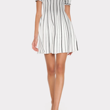 Woman wearing a black and white striped dress on a white background