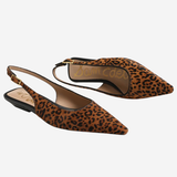 A pair of pointed-toe slingback flats in brown and black leopard print, shown on a light gray background. The brand name 'SOMMER CAESAR' is visible on the insole.