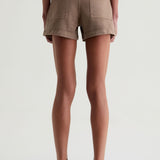 Person wearing brown shorts on a white background