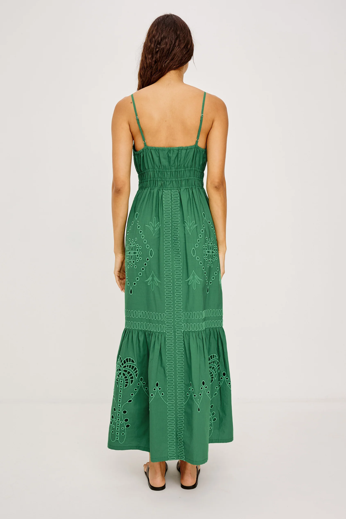 Green dress with intricate patterns on a white background