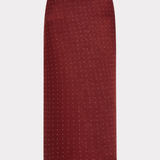 A dark red skirt with a small white geometric pattern, shown flat against a light gray background.