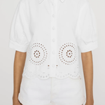 white eyelet button down shirt on woman on white background 