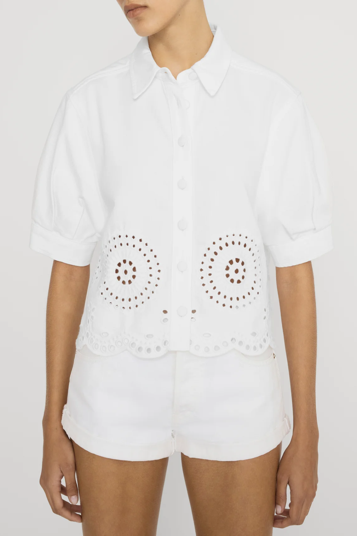 white eyelet button down shirt on woman on white background 