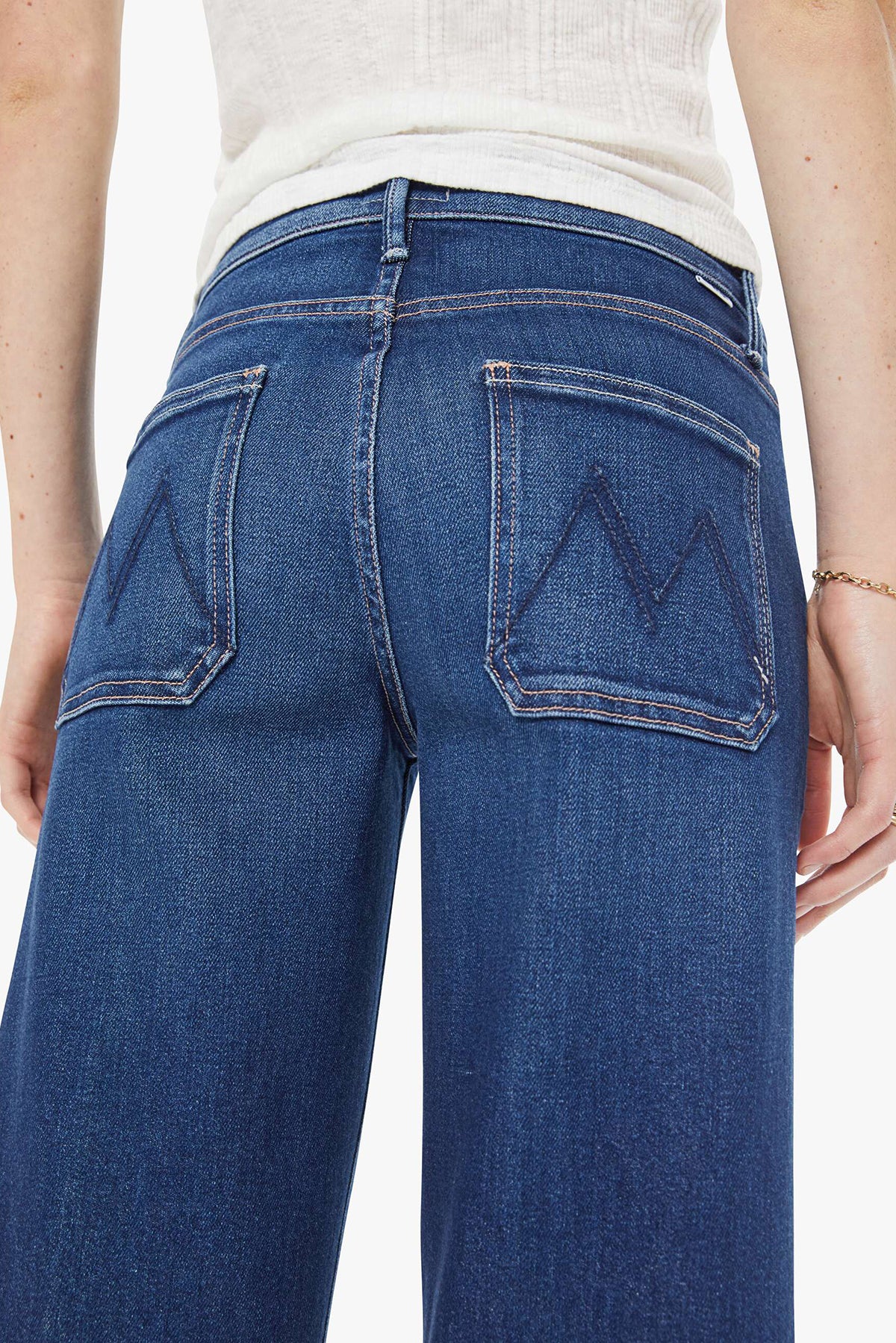 Blue jeans worn by a person on a white background
