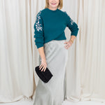 silky slip skirt with a soft drape, styled with a sweater