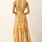 Woman wearing a floral dress on a plain background