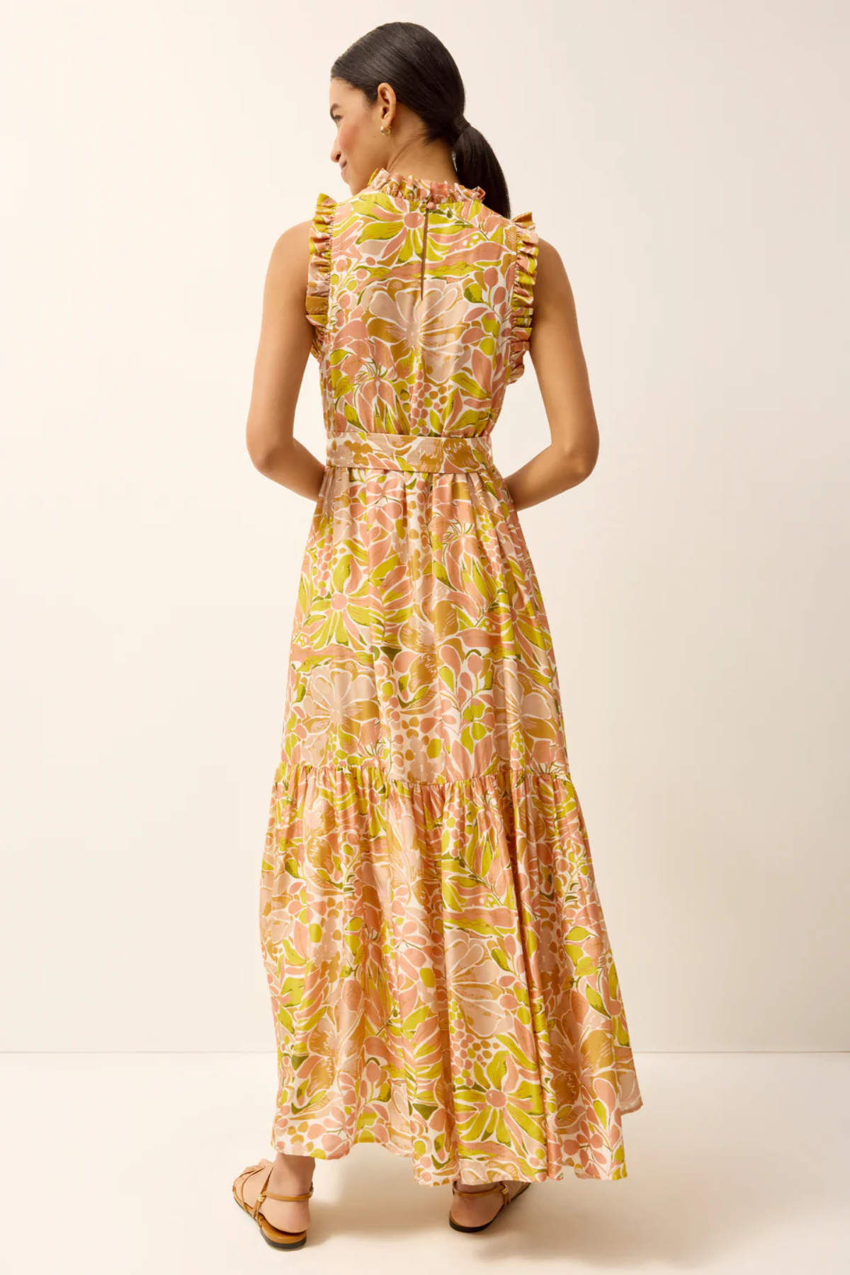 Woman wearing a floral dress on a plain background