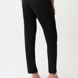 Person wearing black pants on a white background