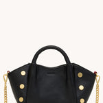 Black Hammitt Paul Mini crossbody bag worn with an evening outfit.