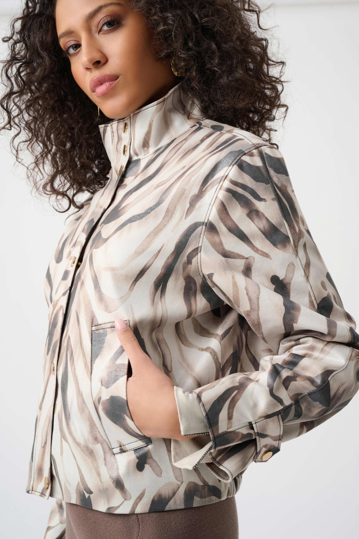 Woman wearing a camouflage-patterned jacket on a white background