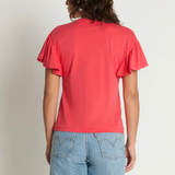 Person wearing a red t-shirt and blue jeans against a plain background