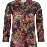 Person wearing l'agence  patterned shirt and jeans on a gray background