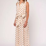 Woman wearing a polka dot dress on a white background