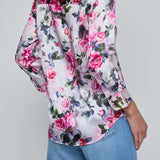 Floral patterned shirt worn by a person on a plain background