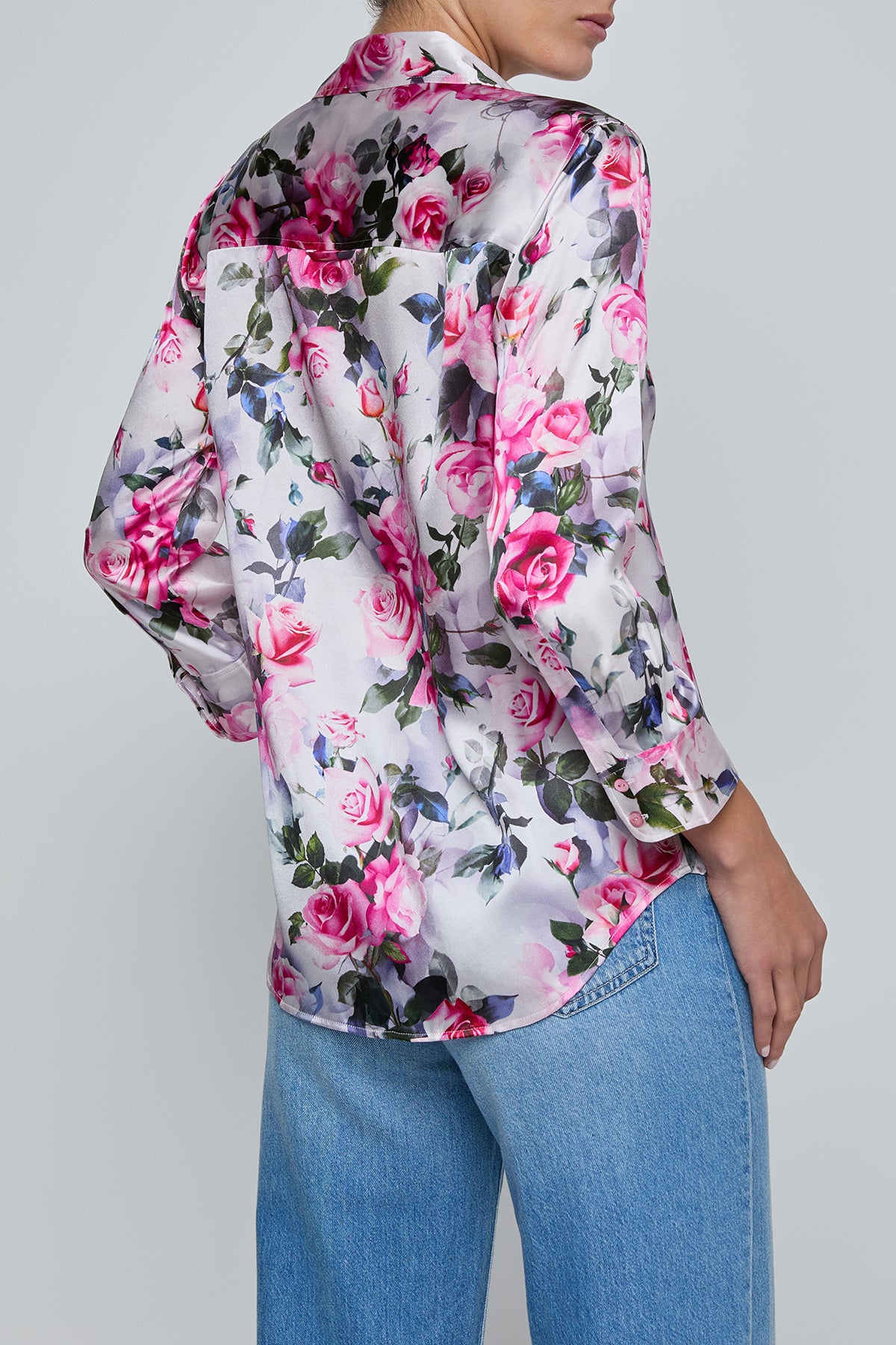 Floral patterned shirt worn by a person on a plain background