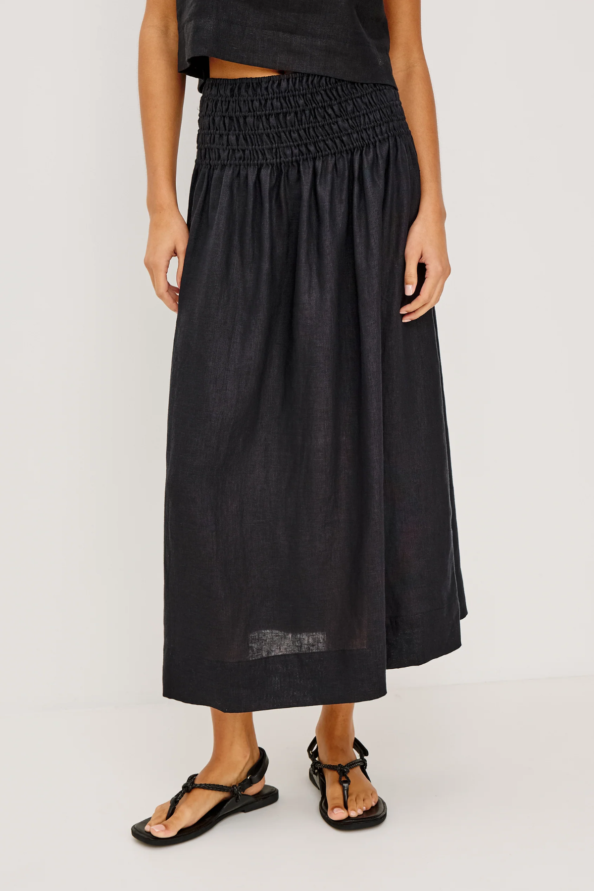 Person wearing a black skirt on a white background