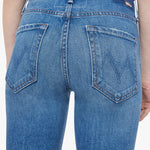 Woman wearing mid-wash cropped flare jeans with a slim upper fit and subtle kick-flare hem.