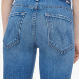 Woman wearing mid-wash cropped flare jeans with a slim upper fit and subtle kick-flare hem.
