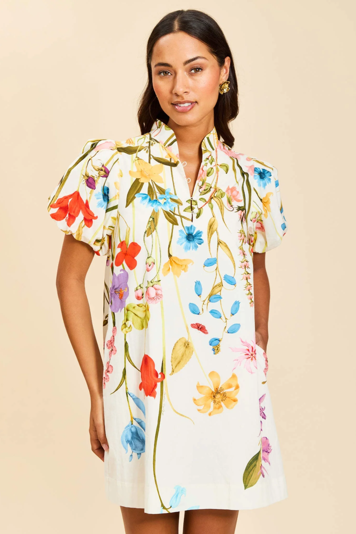 Woman wearing a floral dress against a beige background