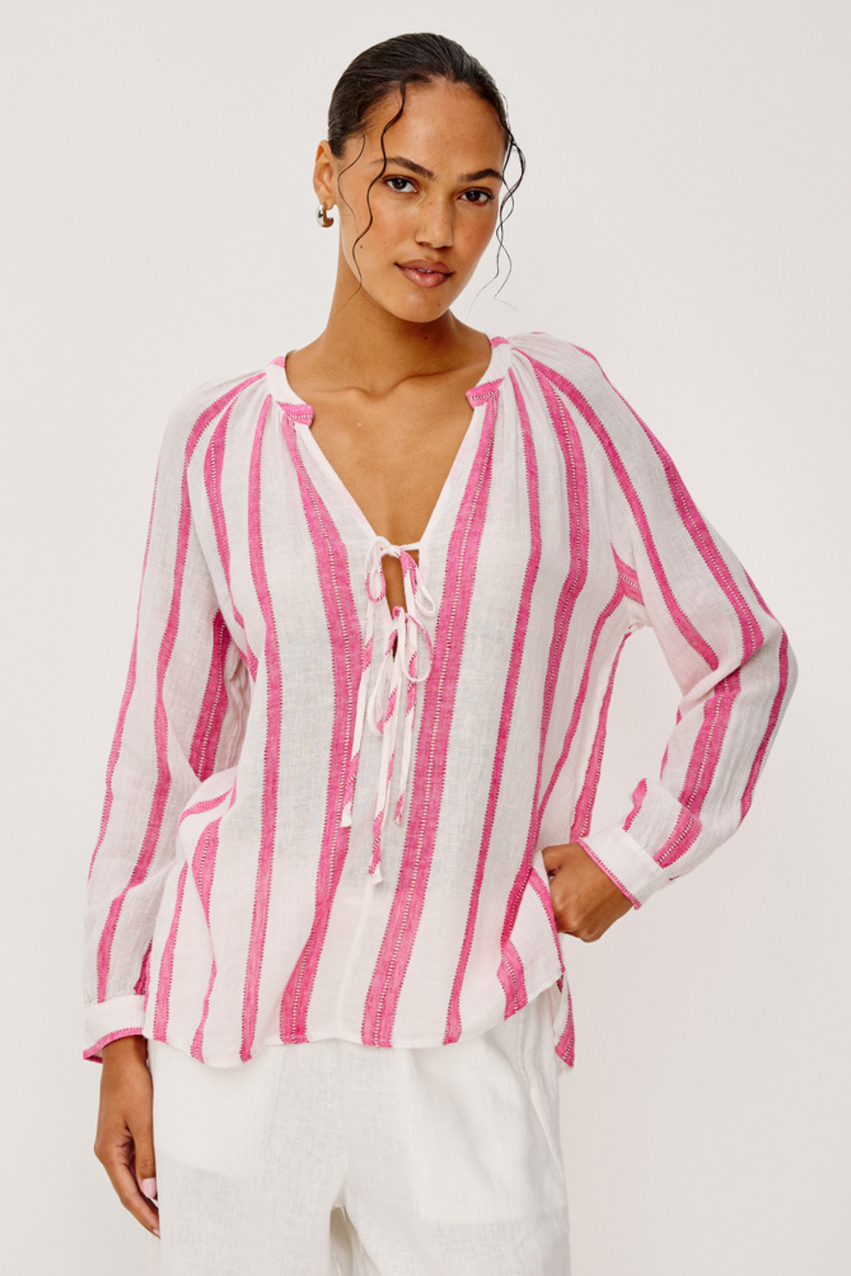woman in white and pink stripe blouse on white background 