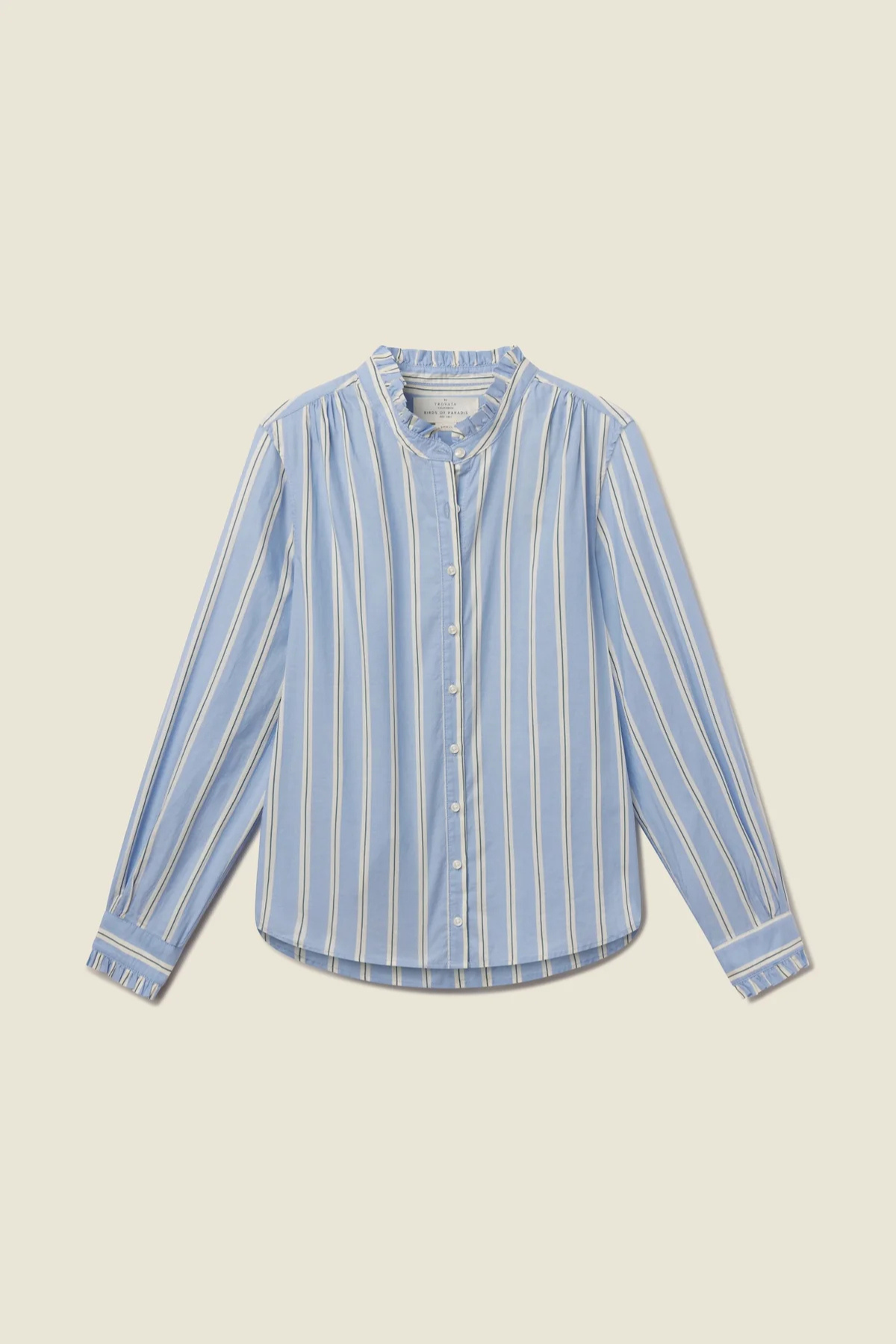 A light blue long-sleeve button-up shirt with vertical white stripes, featuring a high collar and buttoned front, laid flat against a solid beige background.