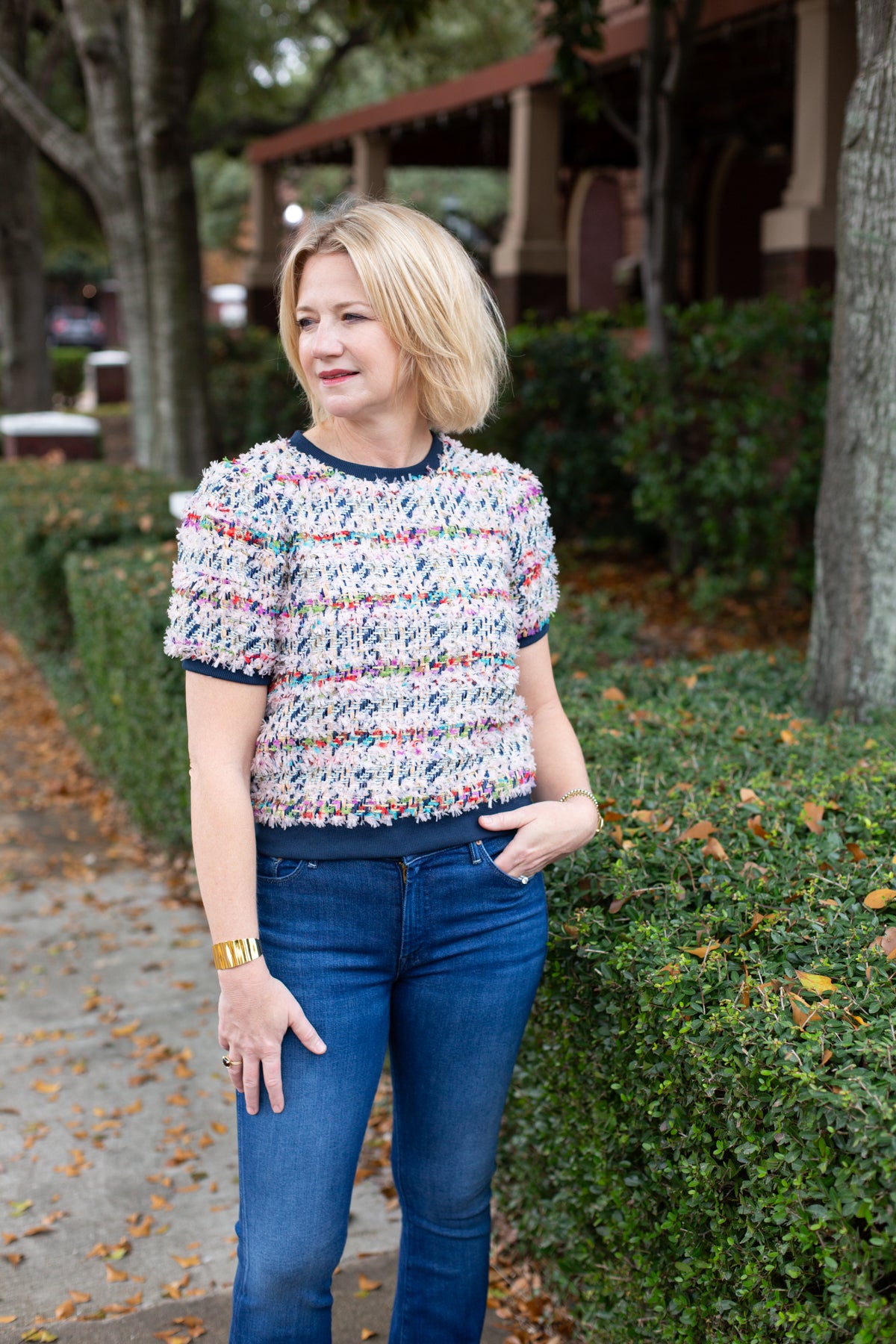 Tweed top with a structured silhouette in neutral tones.
