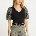 Black short-sleeve top with a clean neckline and soft drape