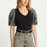 Black short-sleeve top with a clean neckline and soft drape