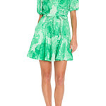 Green floral dress worn by a model on a white background