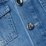 Close-up of blue denim fabric with buttons