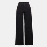 Model wearing dark-wash wide-leg jeans with sailor-inspired button detailing at the waist.