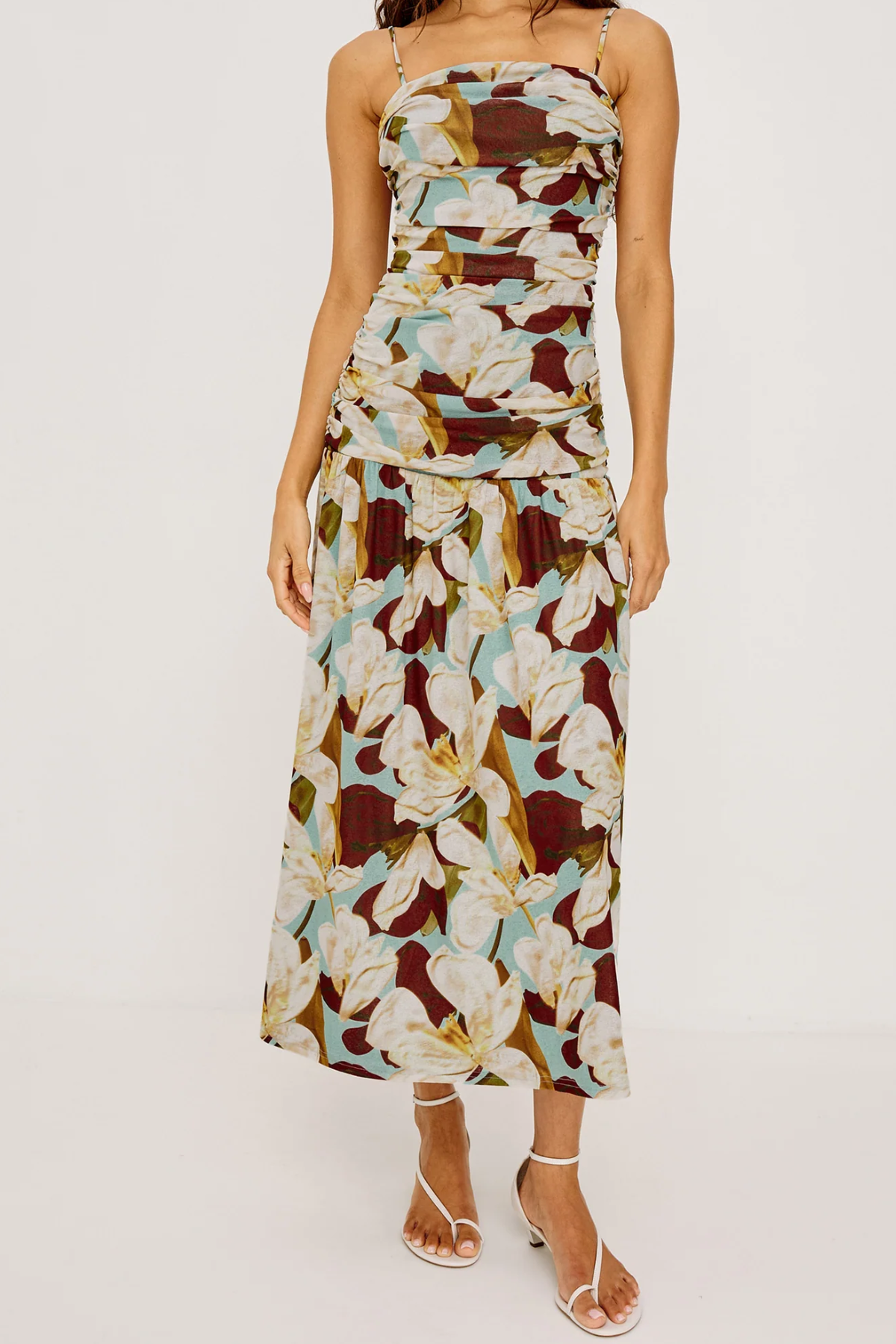 Woman wearing a floral brown pattern dress on a white background