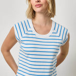Woman wearing a blue and white striped shirt against a plain background