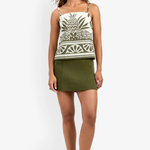 Model wearing a fitted patterned skirt styled with a coordinating sleeveless top for a polished look.