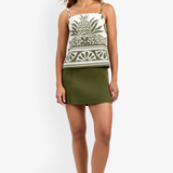 Model wearing a fitted patterned skirt styled with a coordinating sleeveless top for a polished look.