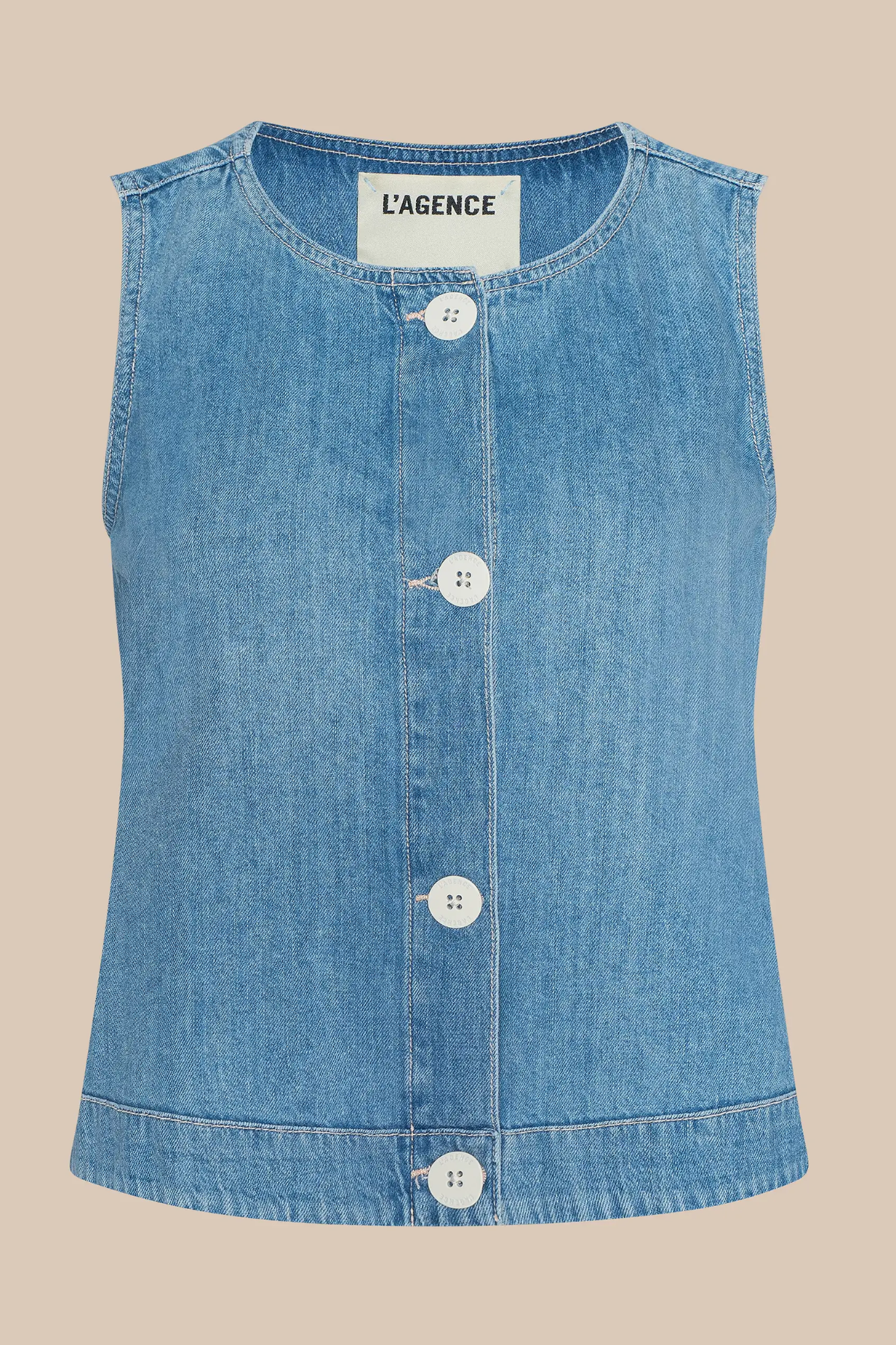 Blue denim vest with buttons on a beige background, featuring the brand 'L'Agence'.