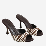 A pair of women's heeled mule sandals featuring a brown and cream zebra-patterned strap and a dark brown insole with the brand name 'D'Amore' visible.