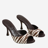 A pair of women's heeled mule sandals featuring a brown and cream zebra-patterned strap and a dark brown insole with the brand name 'D'Amore' visible.