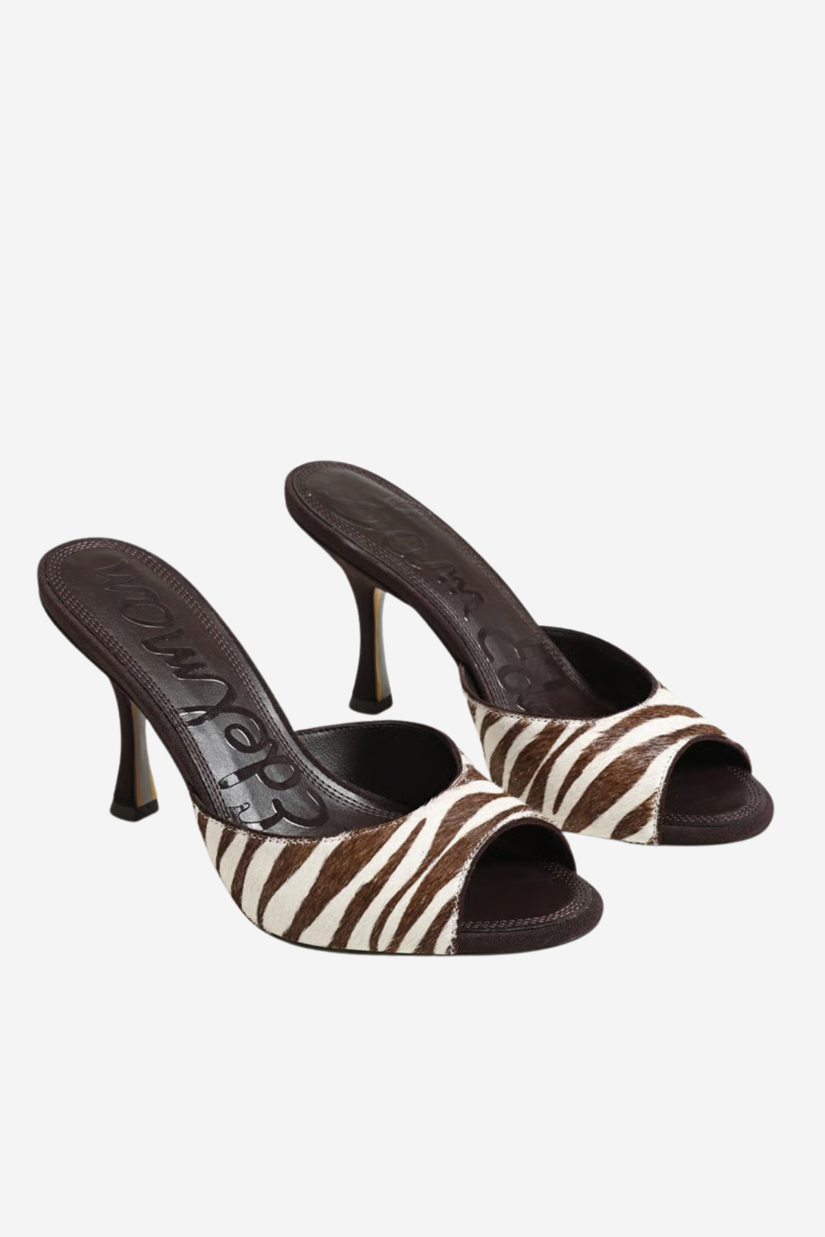 A pair of women's heeled mule sandals featuring a brown and cream zebra-patterned strap and a dark brown insole with the brand name 'D'Amore' visible.