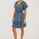 Woman wearing a denim dress on a white background