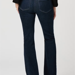 Dark blue jeans worn by a person on a white background