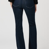 Dark blue jeans worn by a person on a white background