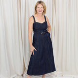 Indigo midi dress with a sweetheart neckline, corset-inspired seams, and a belted waist